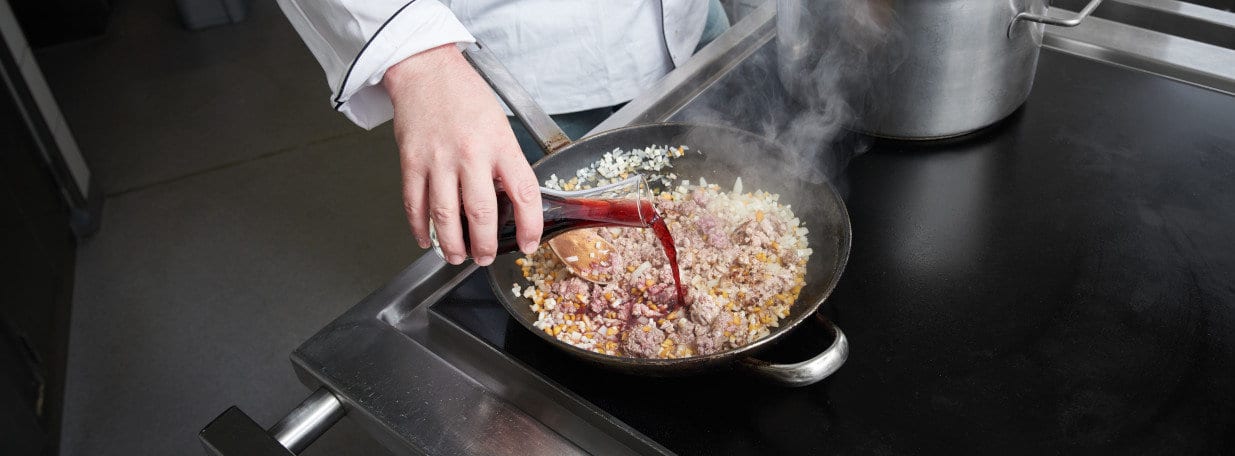 Gemüse-Fleischmischung mit Rotwein ablöschen.