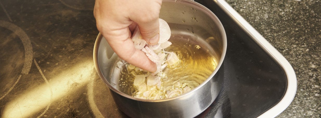 Schalotten und Knoblauch klein schneiden und in wenig Olivenöl andünsten.